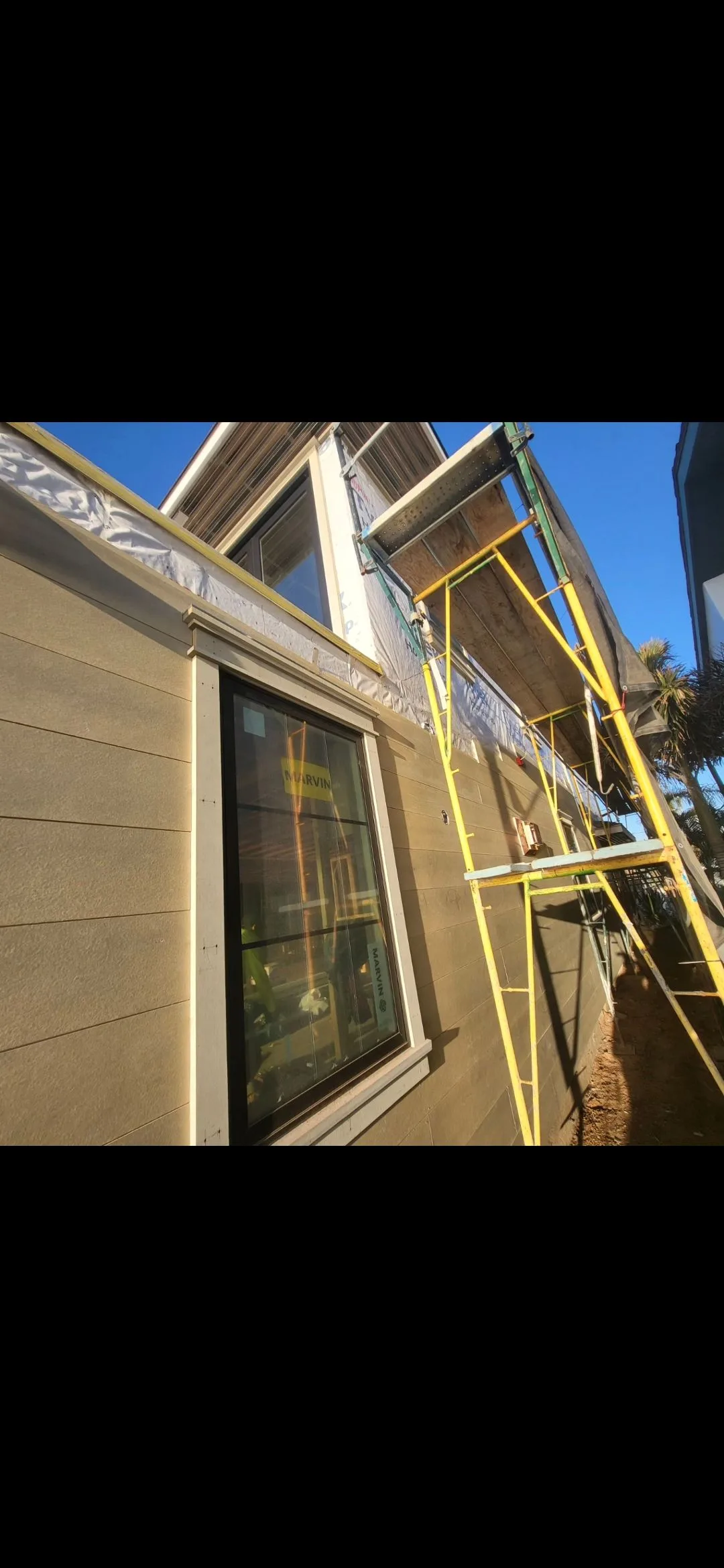 Siding installation project in progress by Fix-It Bear Construction